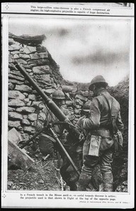 In a French trench in the Meuse section; an aerial torpedo thrower in action; the projectile used is that shown in flight at the top of the opposite page.