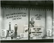 Wartime prices trade board window display urging people to save fat and bones for munitions production.