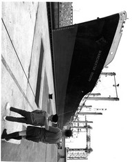 On its first step up the St. Lawrence Seaway, this English freighter enters the St. Lambert Lock near Montréal, Québec. From this point ocean-going ships proceed up the Seaway into the heart of the North American continent. 